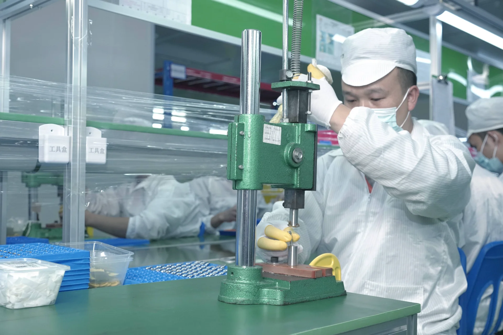 Worker in Cleanroom Using Machine
