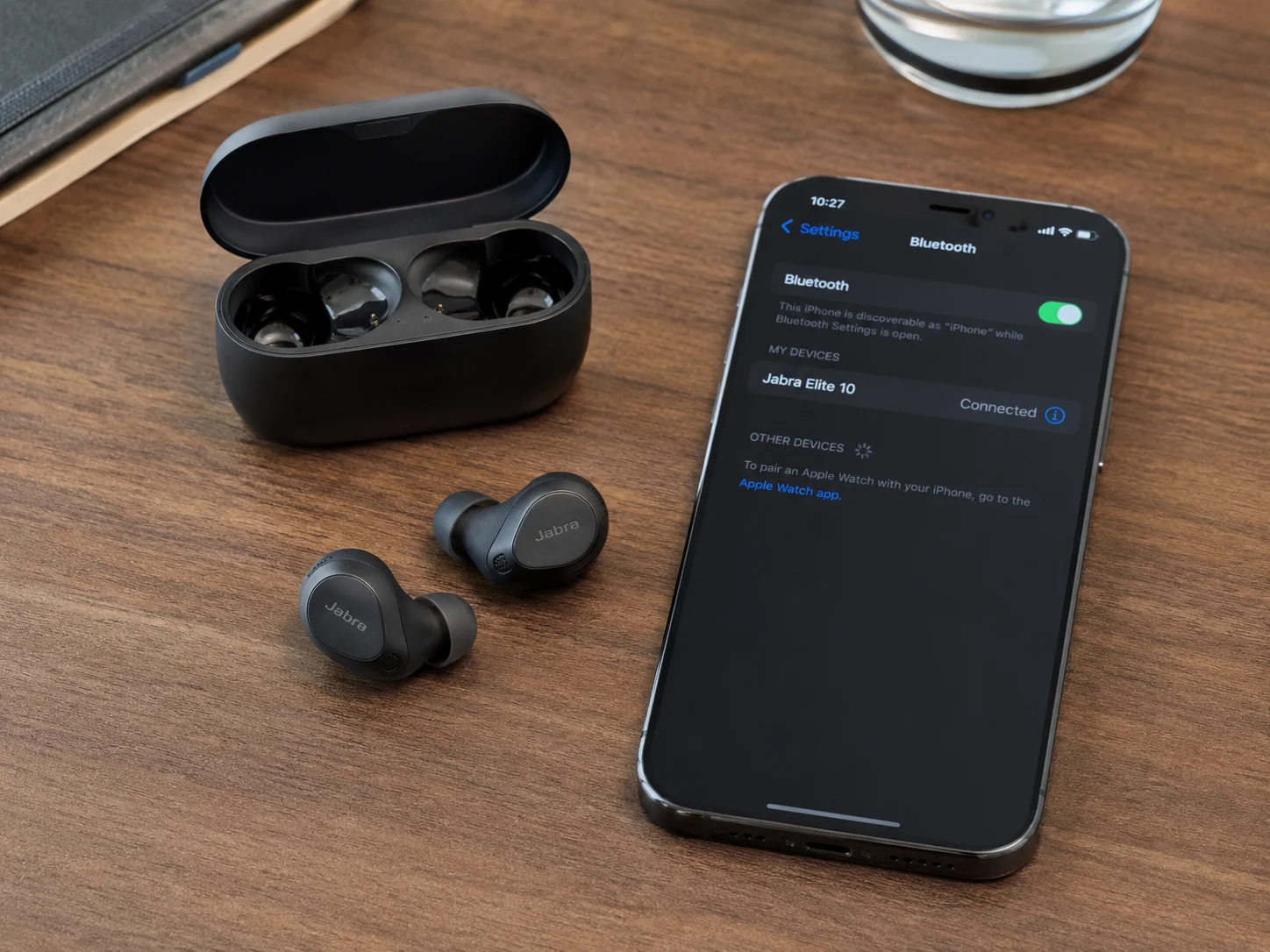 Bluetooth LE Audio Earbuds A pair of modern Bluetooth LE Audio earbuds next to a smartphone