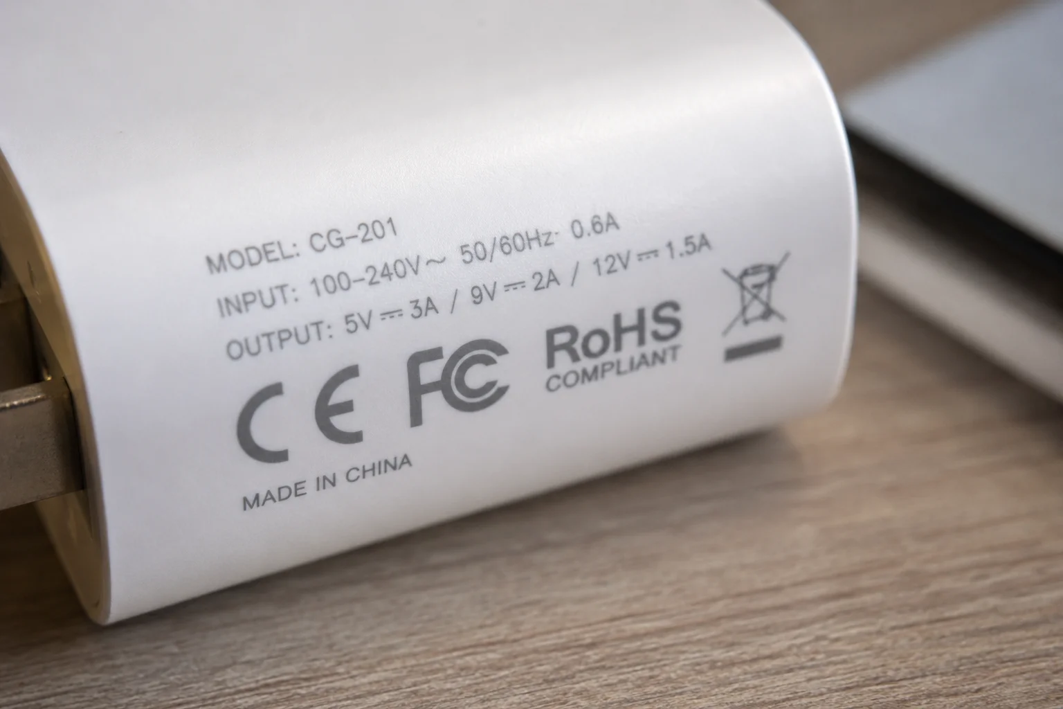 Charger Safety Certifications CE FCC An image showing safety certification marks like CE, FCC, and RoHS on the fine print of a charger.