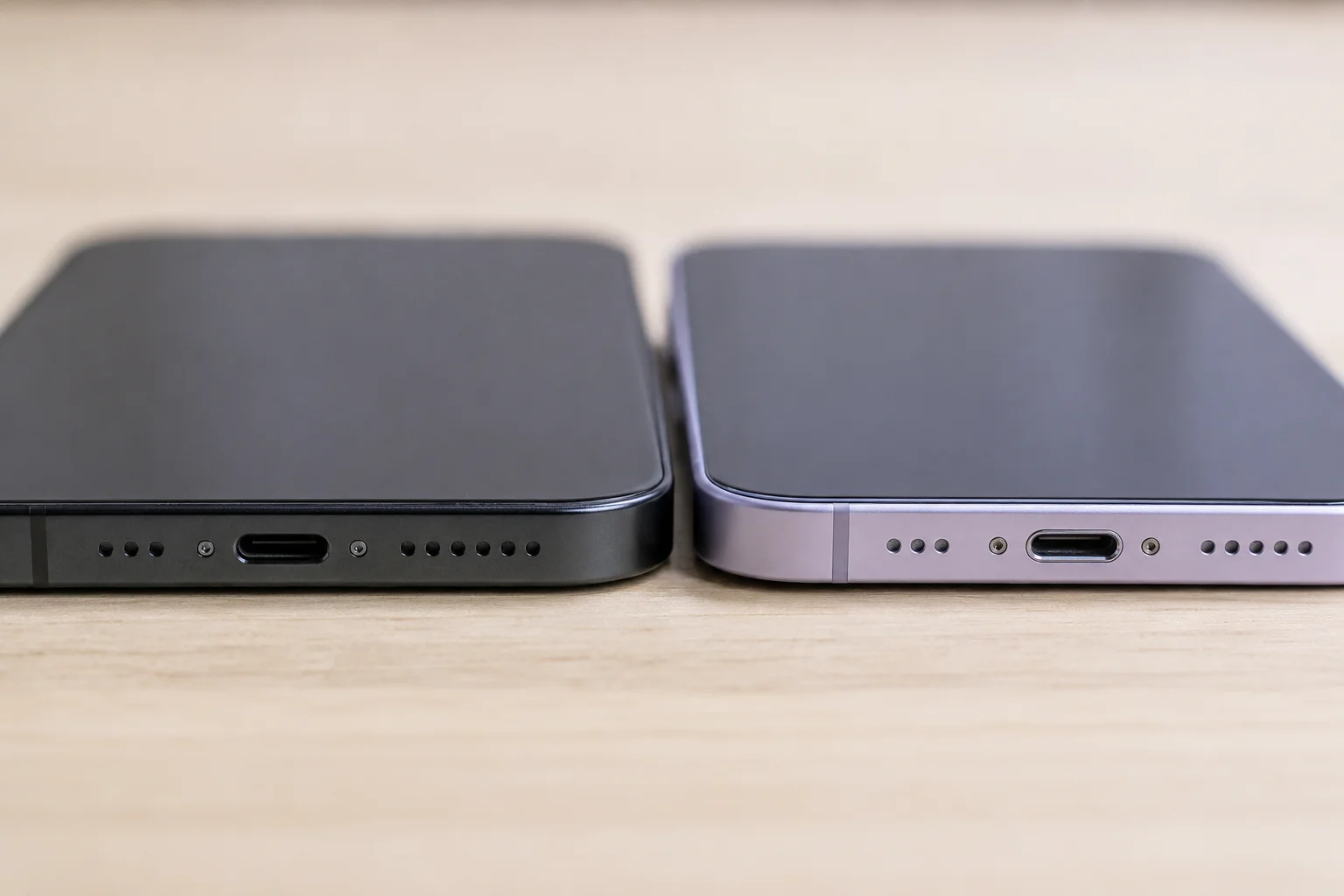 iPhone USB-C and Lightning Ports A close-up shot of a USB-C port on an iPhone 15 next to a Lightning port on an iPhone 14.
