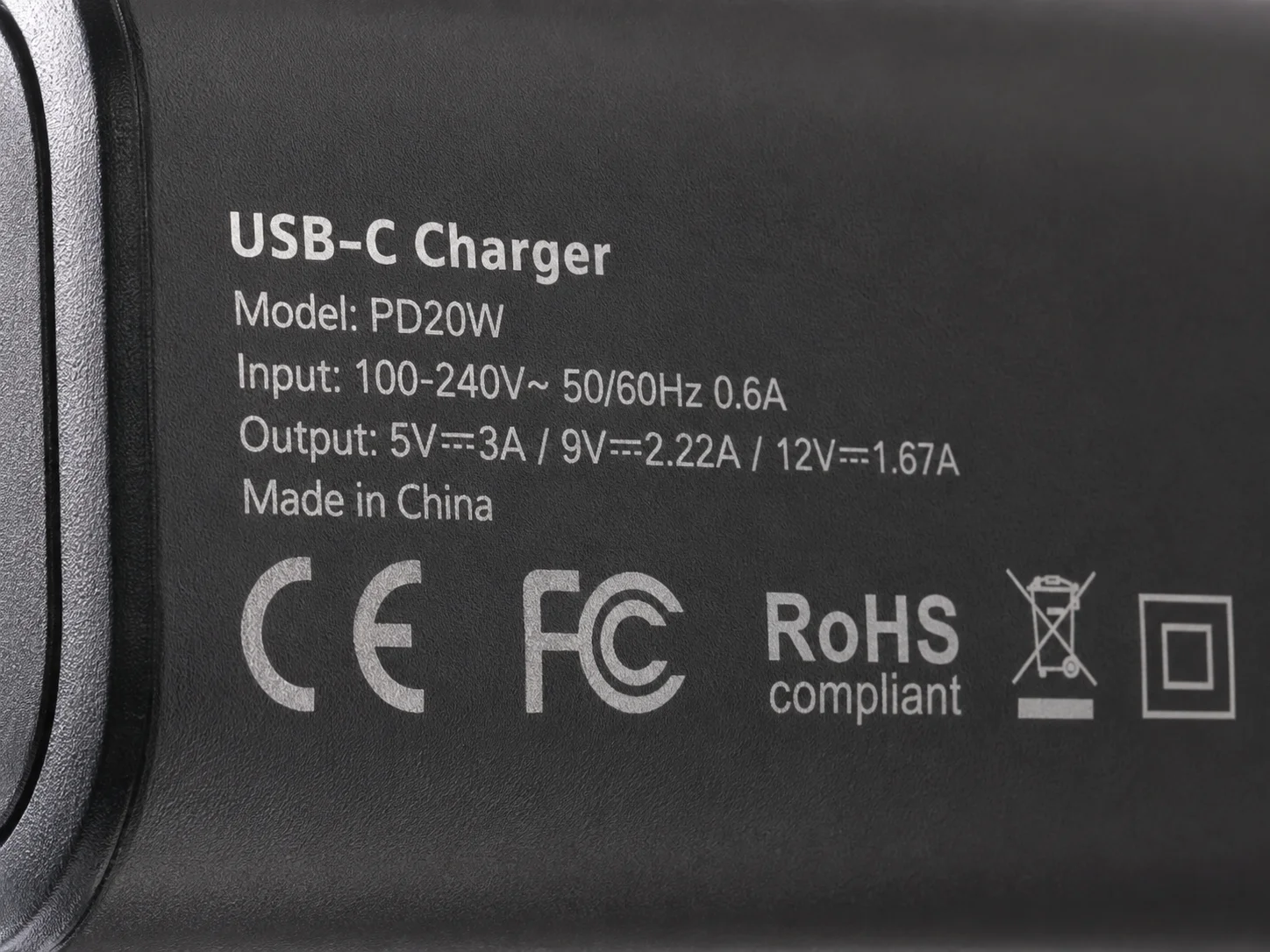 A close-up of safety certification marks on a charger