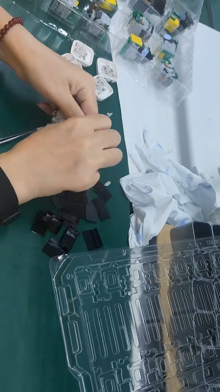 Charger PCBA being fitted into a housing during product assembly